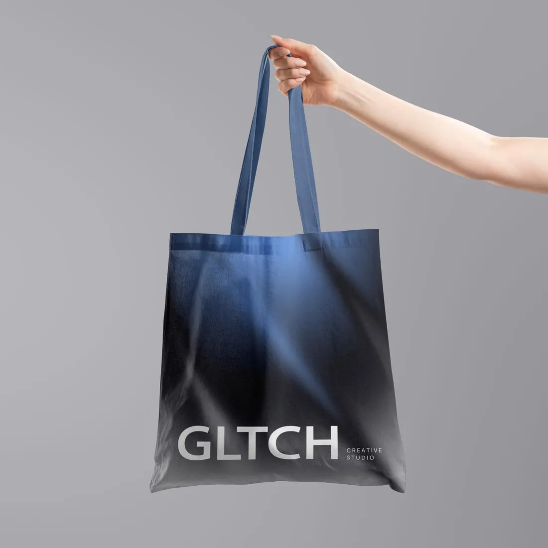GLTCH Creative Studio tote bag with a navy-to-black gradient